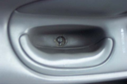 1996 Ford Taurus - Interior door handle detail, showing the screw mechanism.