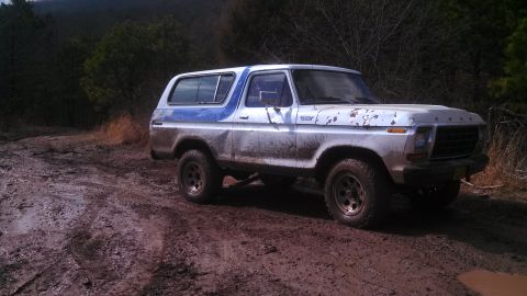 1979 Ford Bronco - Ford Bronco navigating a muddy off-road path.