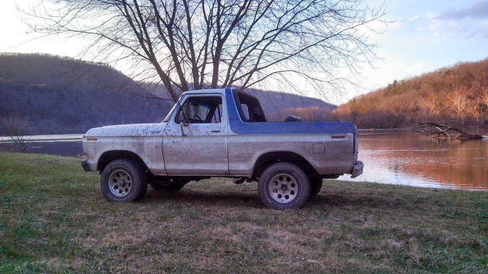 Side view of a 1979 Ford Bronco parked by a river