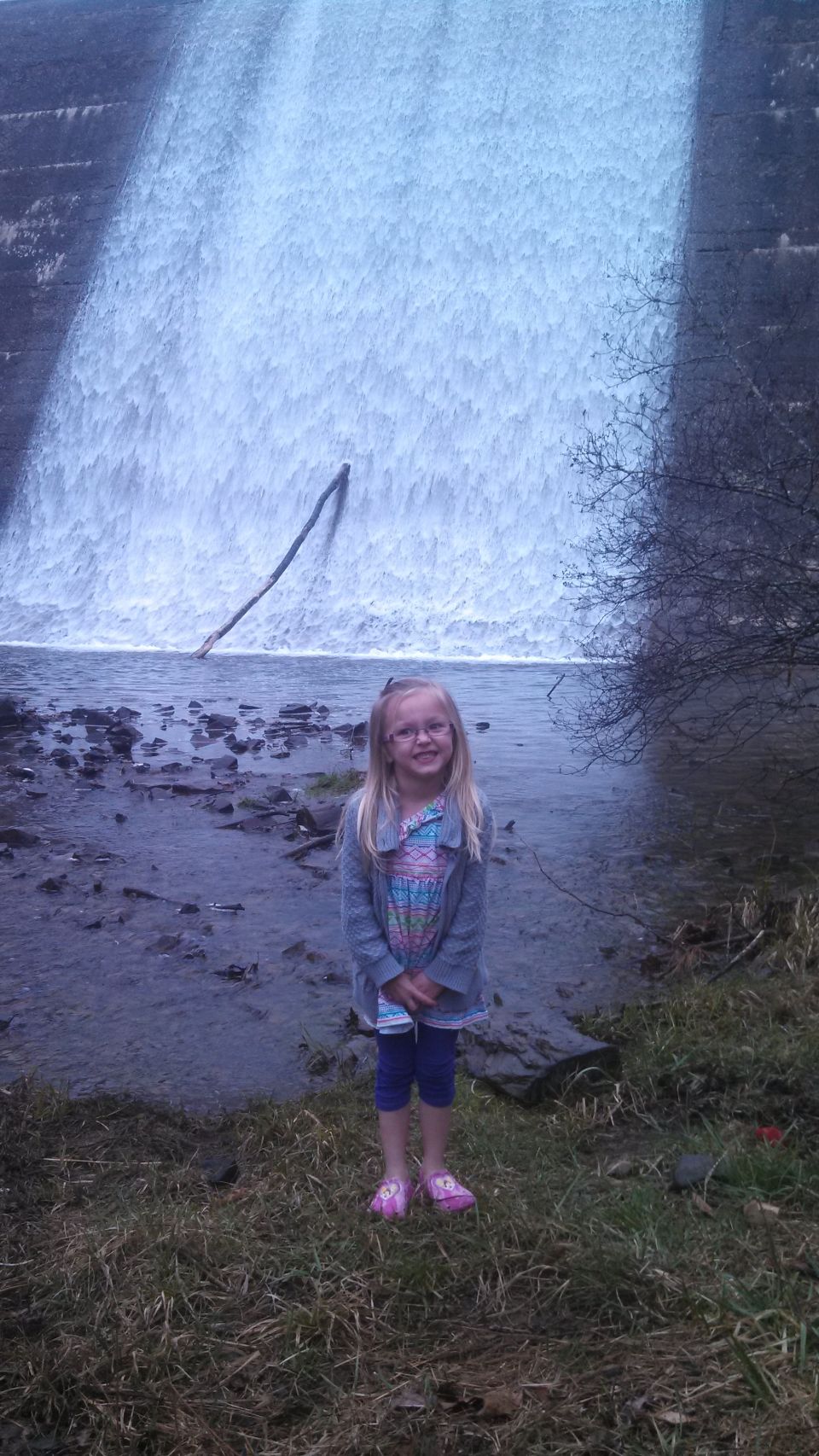 Child in front of a waterfall