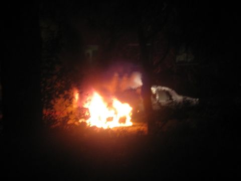 1989 Ford Bronco - A vehicle is burning intensely at night, with smoke and flames obscuring details.