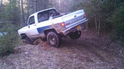 1979 Ford Bronco - This GMC pickup truck is navigating a challenging off-road trail.