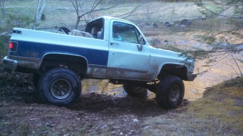 1979 Ford Bronco - This lifted pickup truck appears to be from the 1973-1980 Chevrolet/GMC C/K series.