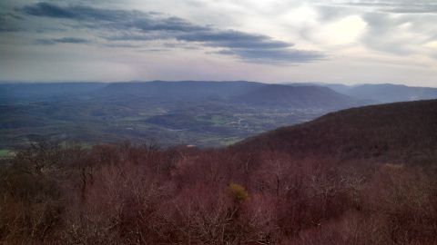 1979 Ford Bronco - View from a mountain overlook showing rolling hills and a valley below.