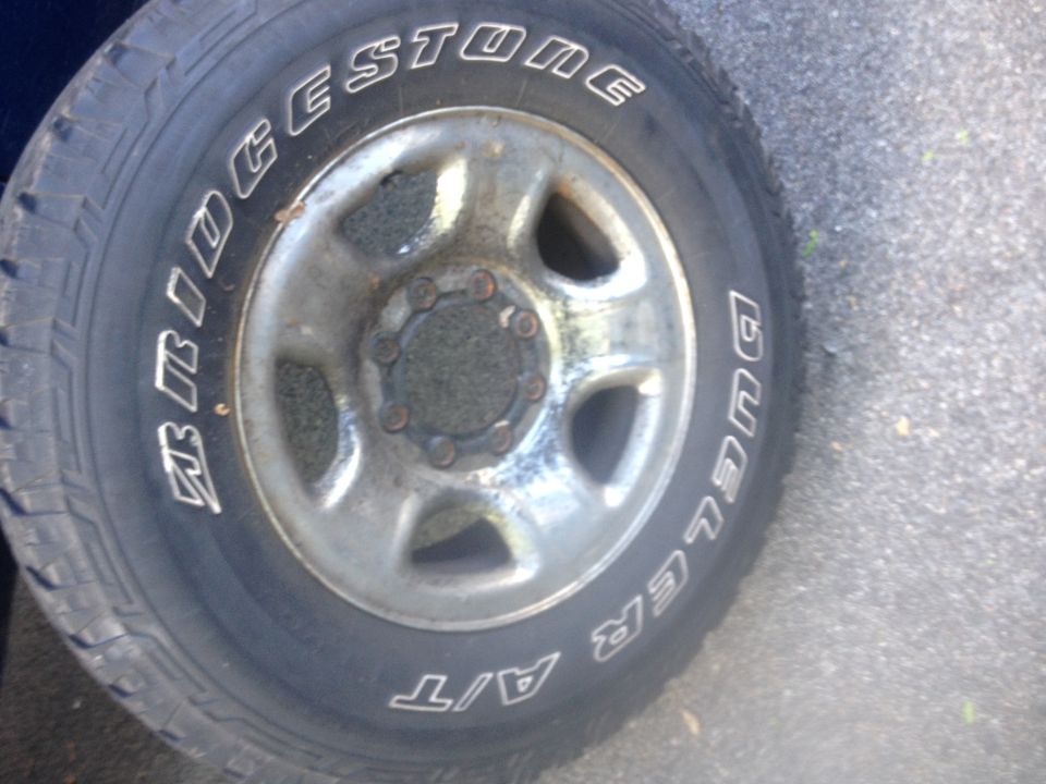 Close-up of a Bridgestone Dueler A/T tire on a silver wheel