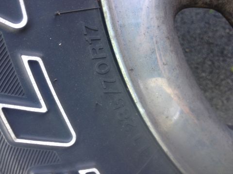 1978 Ford Bronco - Close-up view of a tire and wheel assembly, showing tire size information.