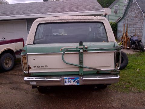 1978 Ford Bronco - This 1978 Ford Bronco features a two-tone green and white paint scheme and a rear-mounted spare tire.