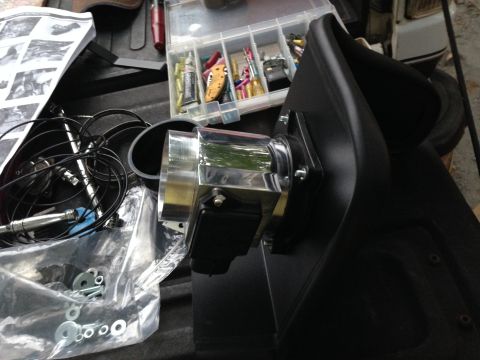 1988 Ford Bronco - Aftermarket air intake part with chrome tubing and black plastic housing, next to tools and instructions.