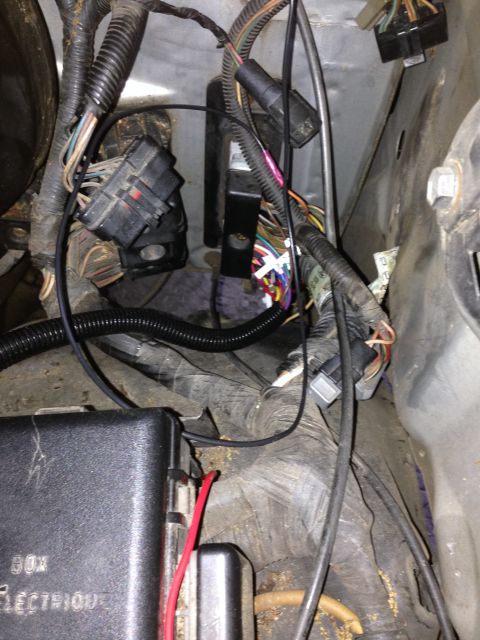 1988 Ford Bronco - Close-up of complex wiring and electrical components in a vehicle's engine bay.