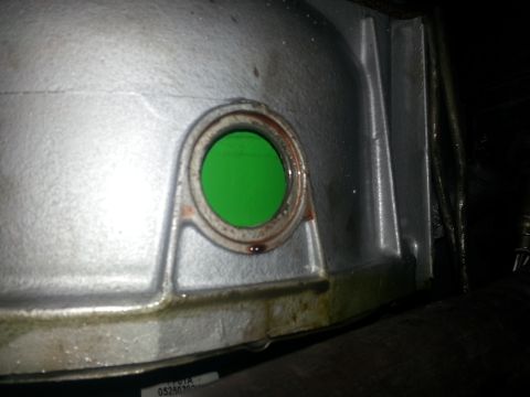 1994 Ford Bronco - Transmission housing detail with green fluid visible through a port, showing signs of oil leakage.