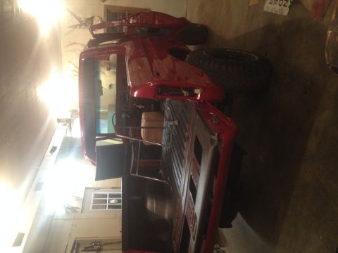1978 Ford Bronco - 1978 Ford Bronco seen from the rear in a garage setting.