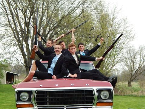 1978 Ford Bronco - Five young men in suits pose with rifles on the hood of a red Ford truck.