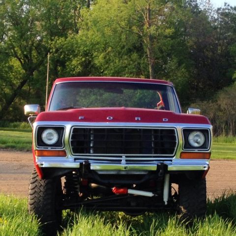 1978 Ford Bronco - Front view of a lifted red Ford truck with a prominent grille and chrome accents.