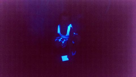 2000 Mercury Grand Marquis - A car's interior glows under blacklight, highlighting the blue accents on the seats and dashboard.