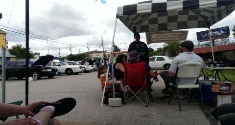 2000 Mercury Grand Marquis - Car show event with multiple vehicles and attendees gathered under a tent.