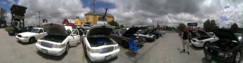 2000 Mercury Grand Marquis - A gathering of 2000 Mercury Grand Marquis cars, many with their hoods open, parked in an outdoor lot.