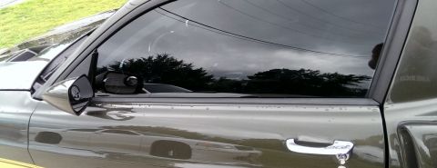 2000 Mercury Grand Marquis - Close-up of a side view mirror and door handle on a vehicle, with "SUPERMOTORS" branding visible on the door.