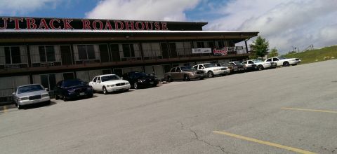 2000 Mercury Grand Marquis - A line of Ford Crown Victoria Police Interceptors are parked outside the Outback Roadhouse.