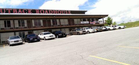 2000 Mercury Grand Marquis - A line of Ford Crown Victoria Police Interceptors are parked outside the Outback Roadhouse.