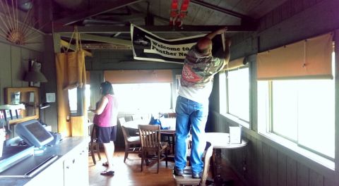 2000 Mercury Grand Marquis - A banner is being hung in a room that appears to be a gathering place.