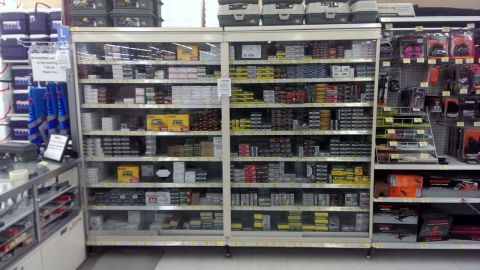 2000 Mercury Grand Marquis - A retail display features numerous shelves filled with boxes of ammunition and related items.