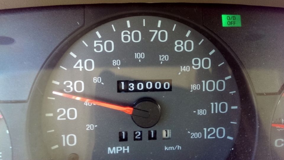 Car dashboard showing speedometer reading 30 MPH and odometer reading 130,000 miles. O/D OFF light is illuminated