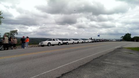 2000 Mercury Grand Marquis - A group of police interceptors are lined up on a scenic overlook, with people standing nearby.