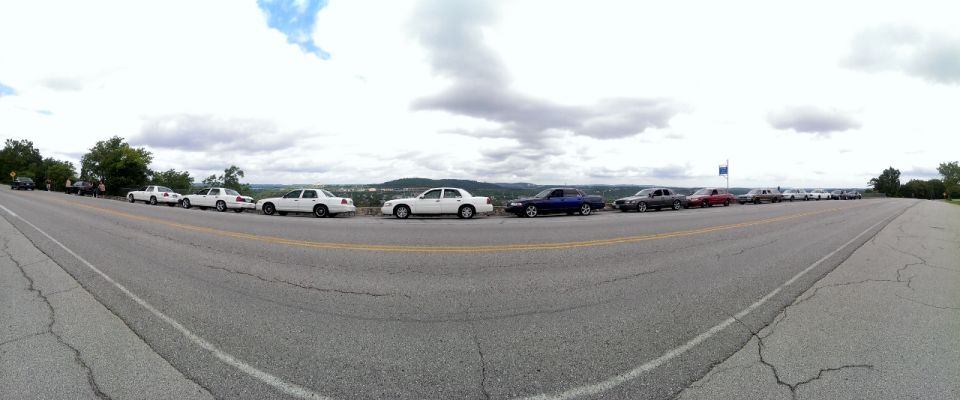 Line of 2000 Mercury Grand Marquis sedans parked on a scenic overlook