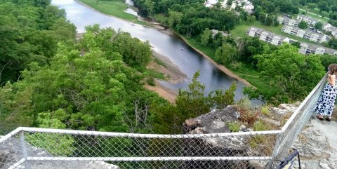 2000 Mercury Grand Marquis - A scenic view from a cliffside, showing a winding river, dense trees, and a distant housing complex.