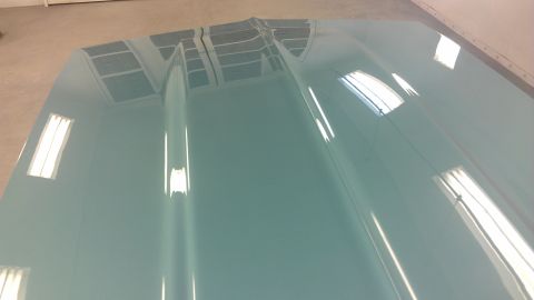2006 Sea-Doo 230 Wake - A glossy, light blue car hood is shown with reflections of ceiling lights on its surface.
