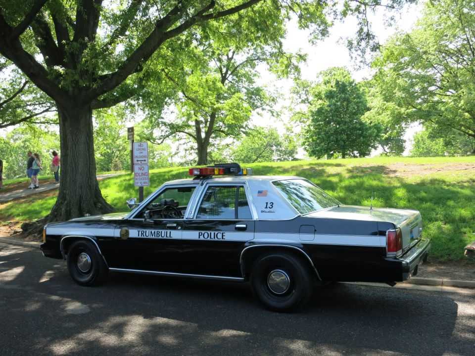 Black and white Trumbull Police Ford LTD Crown Victoria with light bar, number 13
