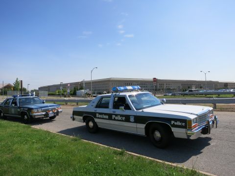 1991 Ford LTD Crown Victoria - black-and-white Boston Police Ford Crown Victoria cruiser parked in front of the Pentagon, with another cruiser behind.