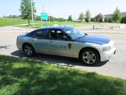 1991 Ford LTD Crown Victoria - silver 'Virginia State Police' Dodge Charger parked roadside with the Pentagon building visible in the background.