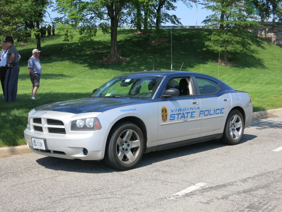 Silver Virginia State Police Dodge Charger, front three-quarter view, people behind