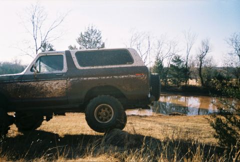1978 Ford Bronco - This 1978 Ford Bronco is covered in mud after an off-road excursion near a small body of water.