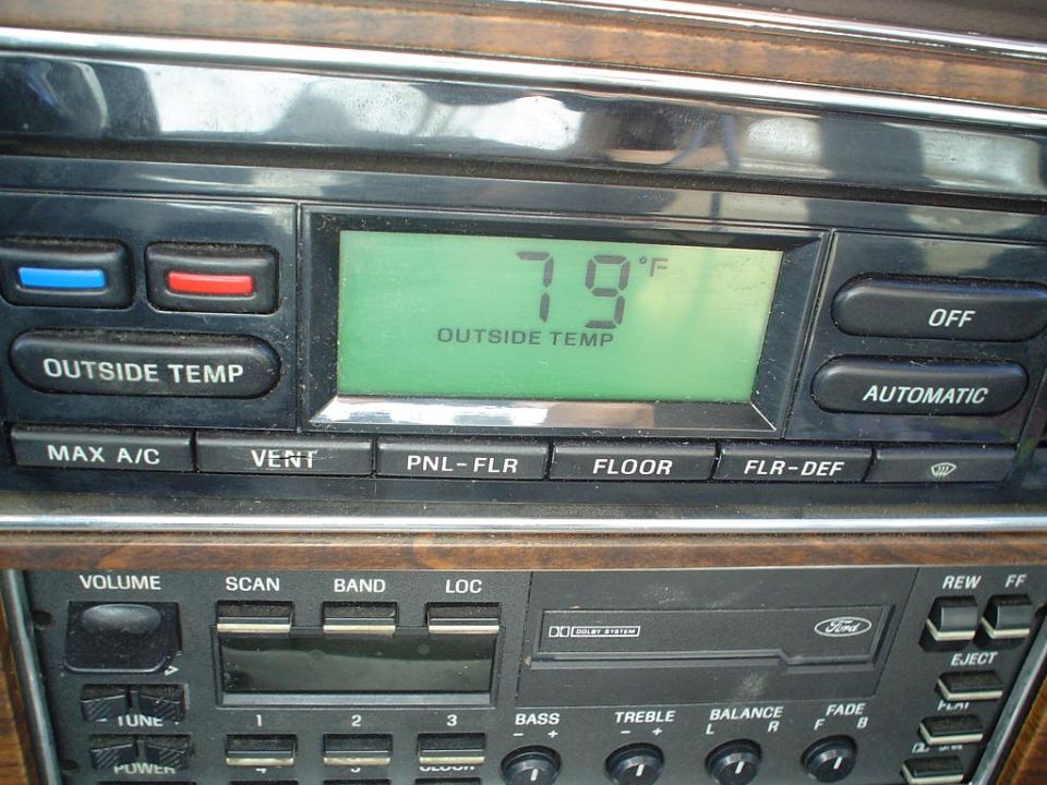 Ford climate control display showing 79°F outside temp above a cassette radio with woodgrain trim