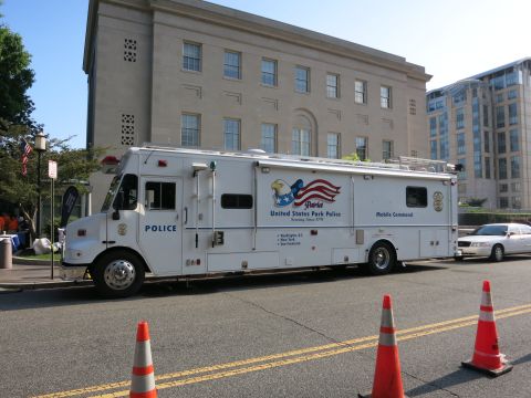1991 Ford LTD Crown Victoria - white United States Park Police Mobile Command truck parked on a street with orange traffic cones in the foreground.