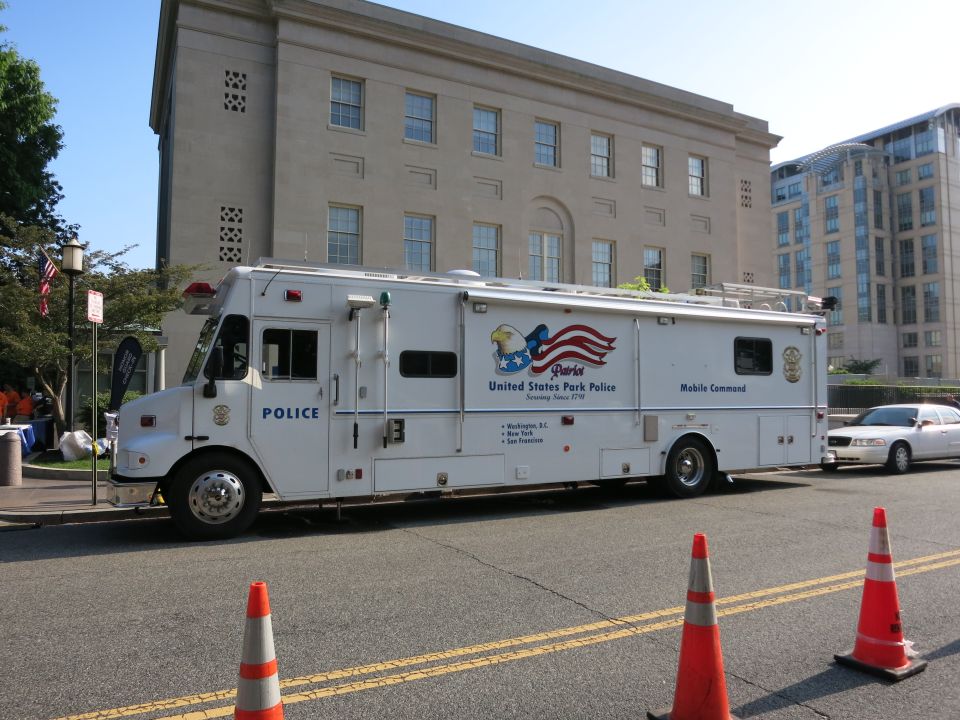 White US Park Police mobile command truck with traffic cones on street