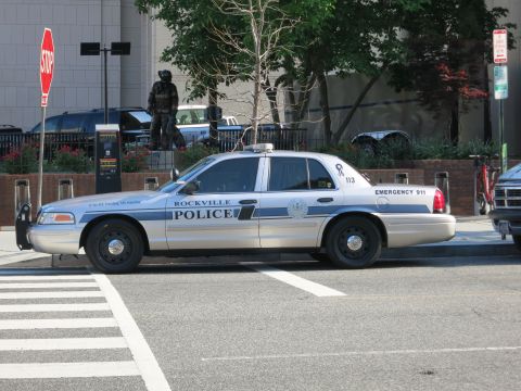 1991 Ford LTD Crown Victoria - silver and blue Ford Crown Victoria marked Rockville Police is parked near a stop sign and crosswalk.