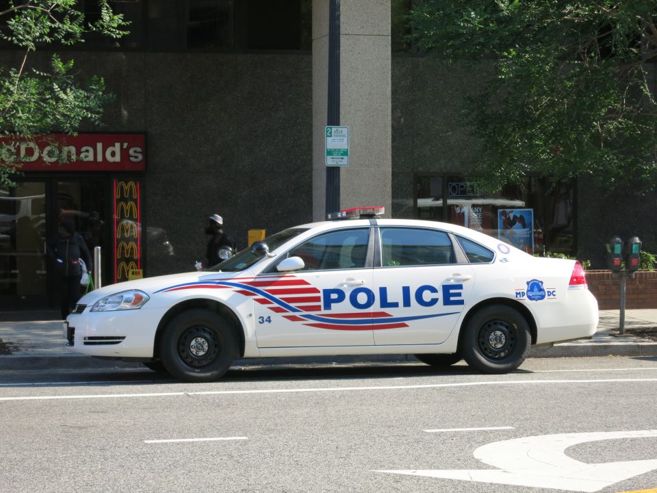 White Chevrolet Impala DC Police car parked outside McDonald's restaurant