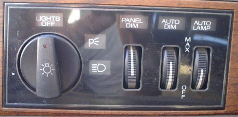 1989 Lincoln Continental - Dashboard light controls including headlight selector and dimmer knobs.