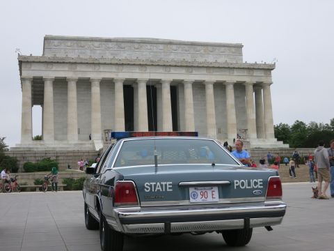 1991 Ford LTD Crown Victoria - Rear view of a blue Ford STATE POLICE sedan marked 90 E parked before the columns of the Lincoln Memorial.