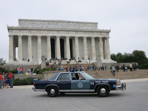 1991 Ford LTD Crown Victoria - blue STATE POLICE sedan numbered 90E parked on the plaza in front of the Lincoln Memorial with crowds on the steps.
