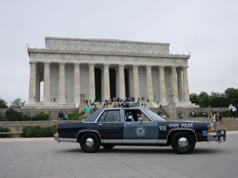 1991 Ford LTD Crown Victoria - blue STATE POLICE sedan numbered 90E parked on the open plaza in front of the Lincoln Memorial.