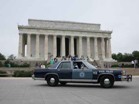 1991 Ford LTD Crown Victoria - blue STATE POLICE sedan numbered 90E parked on the plaza before the columns and steps of the Lincoln Memorial.