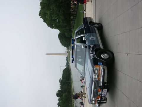 1991 Ford LTD Crown Victoria - navy and silver "State Police 90E" Ford cruiser parked at a three-quarter angle facing the Reflecting Pool and Washington Monument.