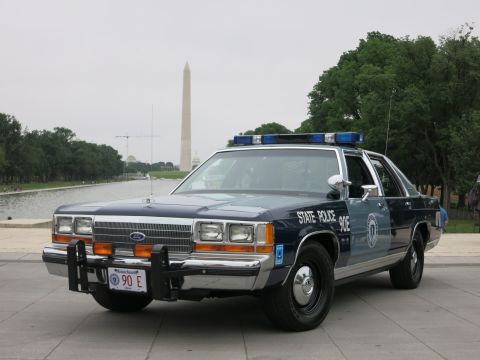 1991 Ford LTD Crown Victoria - navy and silver "State Police 90E" Ford cruiser with push bar photographed near the Reflecting Pool with the Washington Monument behind.