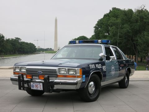 1991 Ford LTD Crown Victoria - navy and silver "State Police 90E" Ford cruiser parked beside the Reflecting Pool with the Washington Monument in the hazy distance.