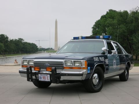 1991 Ford LTD Crown Victoria - navy and silver "State Police 90E" Ford cruiser with push bar parked near the Reflecting Pool with the Washington Monument in the backgroun…