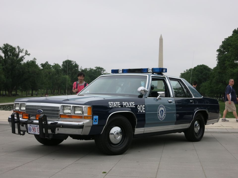 Blue and silver State Police Ford patrol sedan with onlookers, Washington Monument
